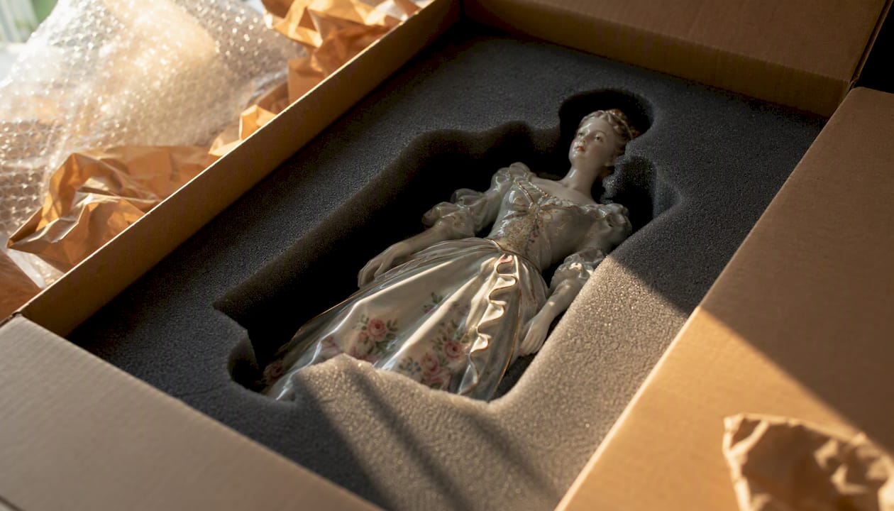 Antique figurine nestled in custom foam inserts