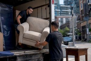 Movers loading furniture for donation pickup