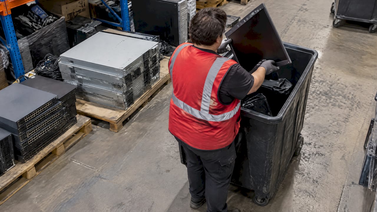 Technician sorting office electronics for recycling