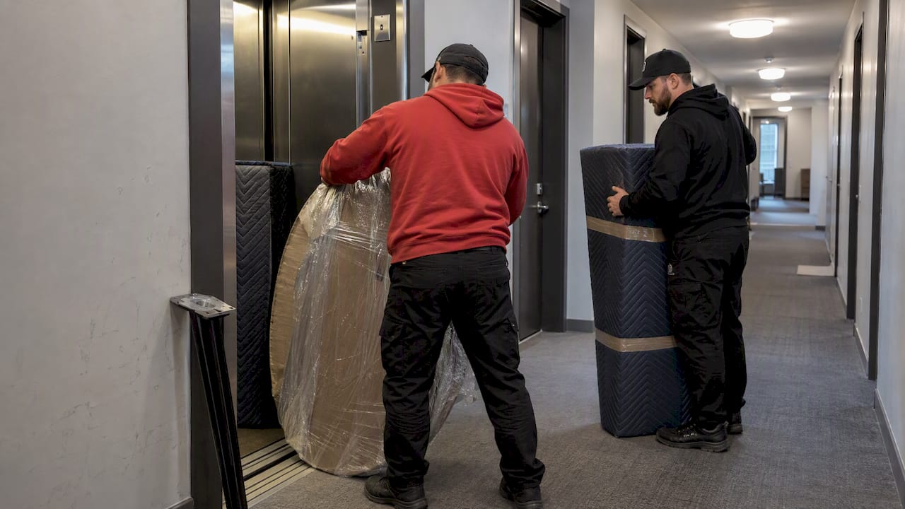 Movers handling disassembled furniture